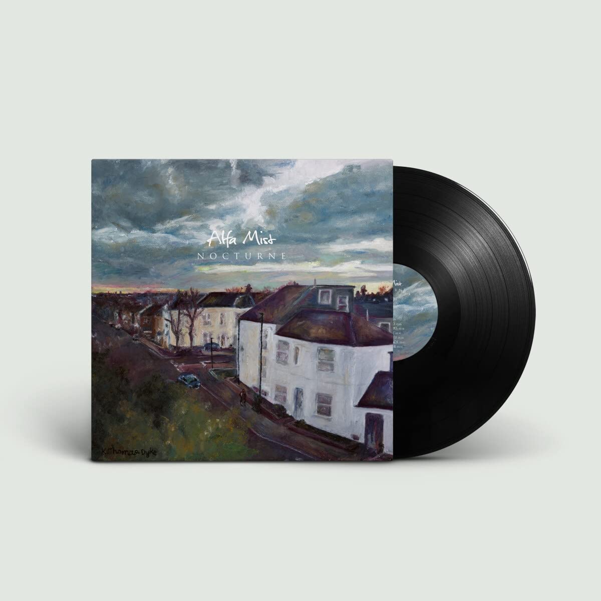 "Vinyl record with cover art featuring a painted cityscape under a cloudy sky."