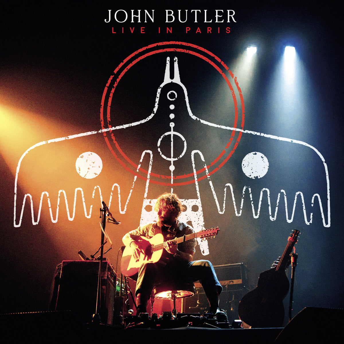 John Butler album cover: musician playing guitar on stage with graphic overlay.