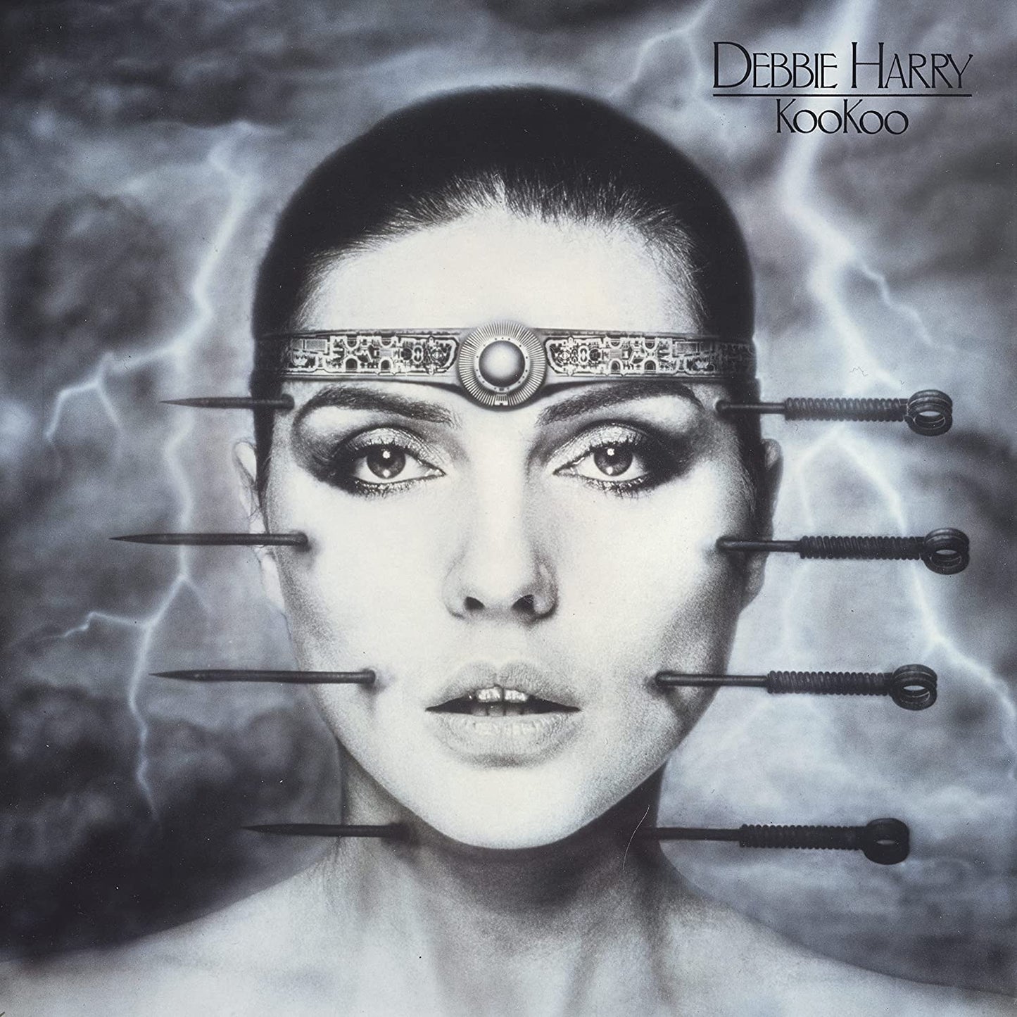Black and white album cover featuring Debbie Harry with pins around her face.