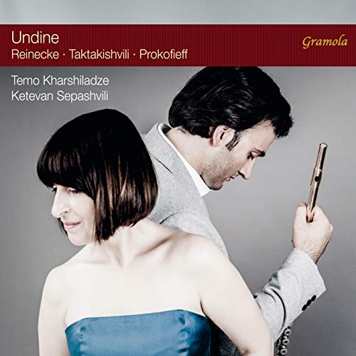 CD cover featuring a man and woman, with red banner and white text.