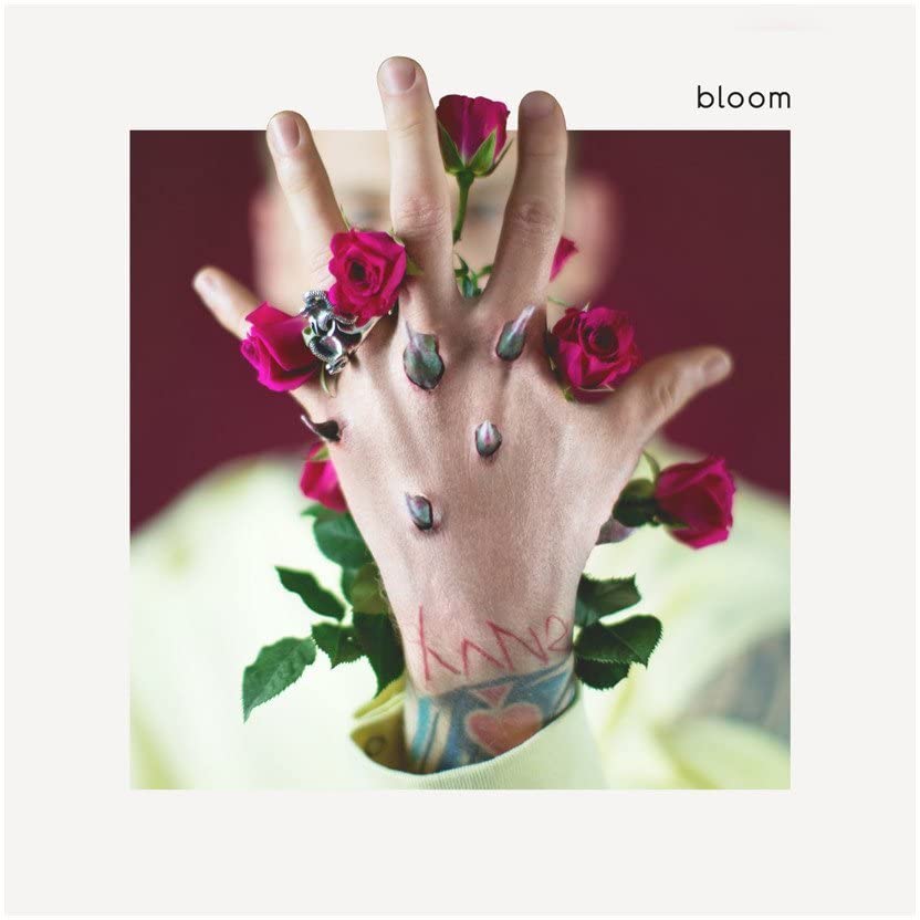 Hand with roses and tattoos, album cover for Machine Gun Kelly’s “bloom.”