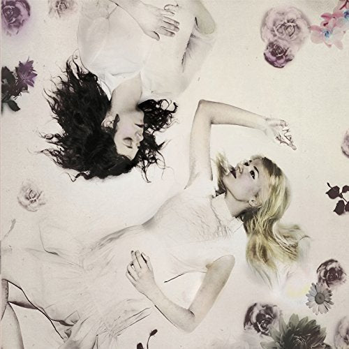 The image is a CD cover featuring two women lying on a white background with flowers. Here is a concise alt text: "CD cover with two women surrounded by flowers."