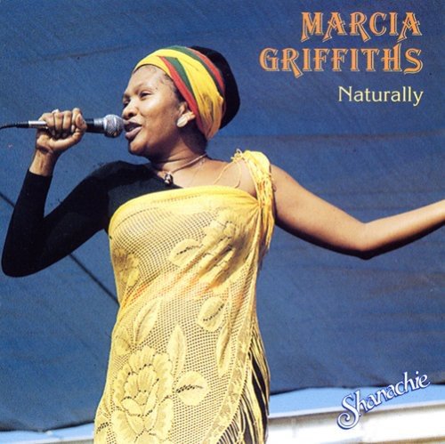 "Album cover of Marcia Griffiths singing into a microphone, wearing a yellow dress."