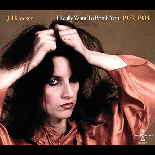Jill Kroesen album cover: woman with dark hair, orange background.