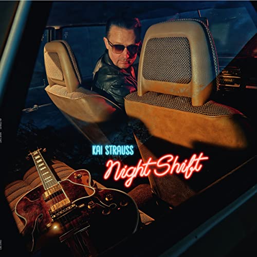 Kai Strauss album cover: man with guitar in a car at night.