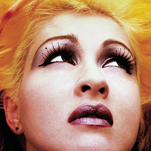 Close-up of Cyndi Lauper with bright blonde hair and dramatic makeup.