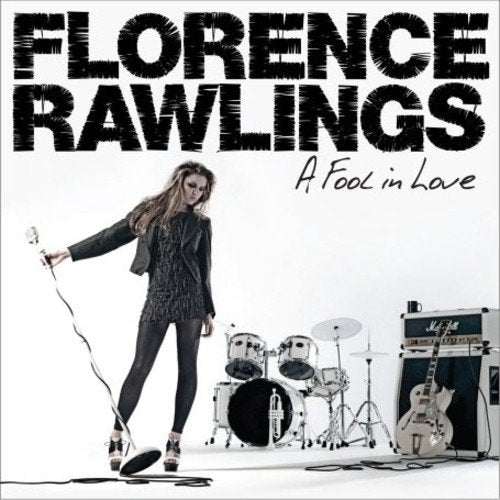 "Album cover featuring a woman holding a microphone, surrounded by musical equipment."