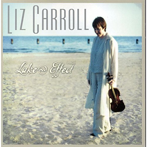 "Liz Carroll's 'Lake Effect' CD cover: a woman on a sandy beach, holding a violin case."