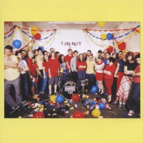 Group of people in a room decorated with balloons and streamers.