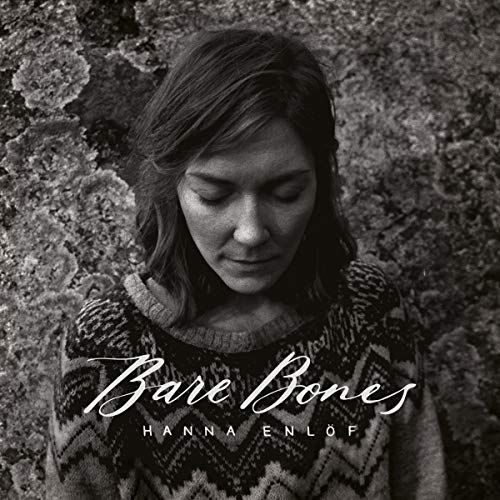 Black and white album cover featuring a woman with downward gaze.