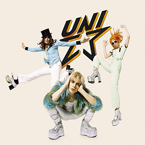 Album cover featuring three people in flamboyant outfits and platform boots.