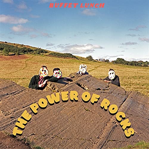Album cover: four figures with masks sit on a large rock in a field.