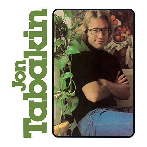 Vinyl album cover featuring a man with glasses sitting by a plant.