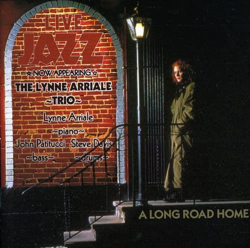 CD cover for Lynne Arriale Trio’s “A Long Road Home” with jazz signage.