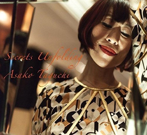 Woman with short red hair and patterned dress on a music CD cover.