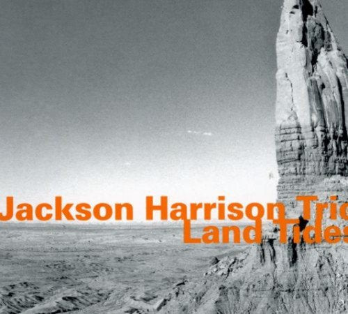 "Album cover with a rock formation and orange text."