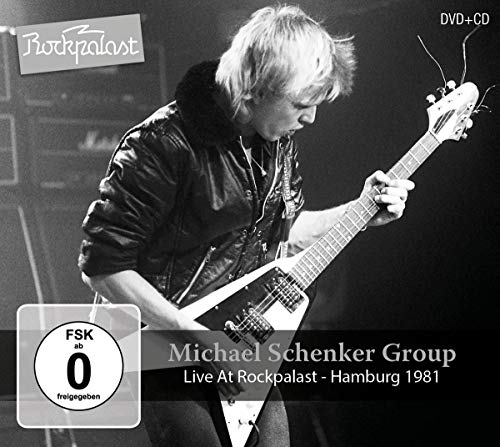 Black and white image of Michael Schenker playing a flying V guitar.