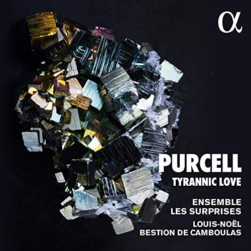 The image is a CD cover for "Purcell: Tyrannic Love" by Ensemble Les Surprises. * The cover features a dark background with a large, irregularly shaped cluster of metallic crystals or fragments in shades of silver, gold, and black. * The title "PURCELL TYRANNIC LOVE" is displayed prominently at the bottom right. * The artist's name is written in smaller text below the title. * The image includes the text "ENSEMBLE LES SUR