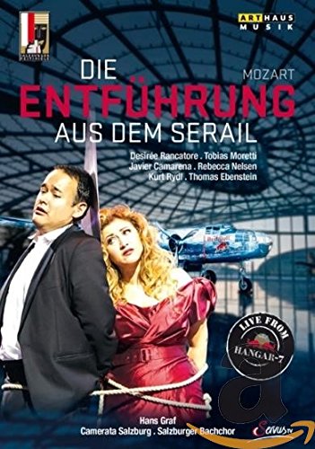 DVD cover featuring a man and woman, with airplane in the background.