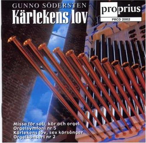 "CD cover featuring a close-up of organ pipes against a brick wall and blue sky."