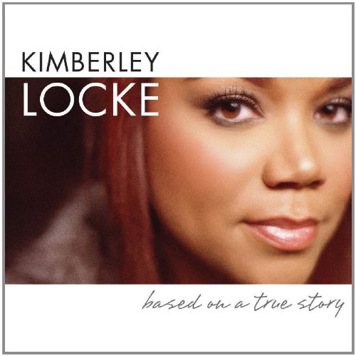 "Album cover featuring a close-up of a woman's face with red hair."