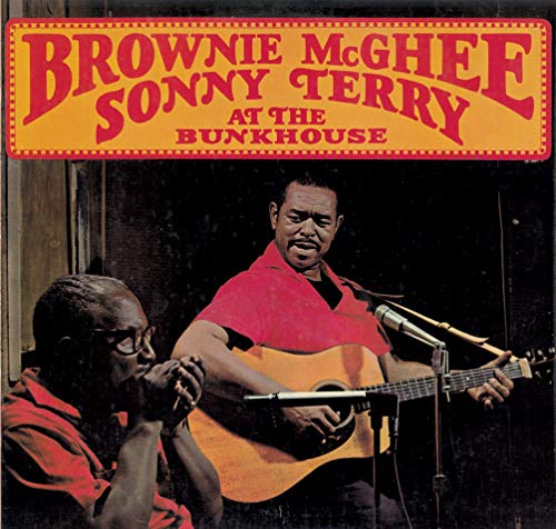 "Album cover with two men, one playing guitar, the other harmonica, against a dark background."