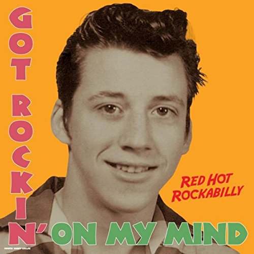 Album cover: black and white portrait of a smiling man, orange background.