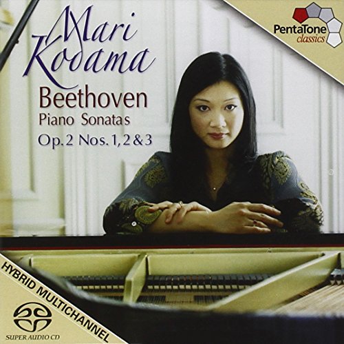 CD cover featuring a woman sitting at a grand piano with text.