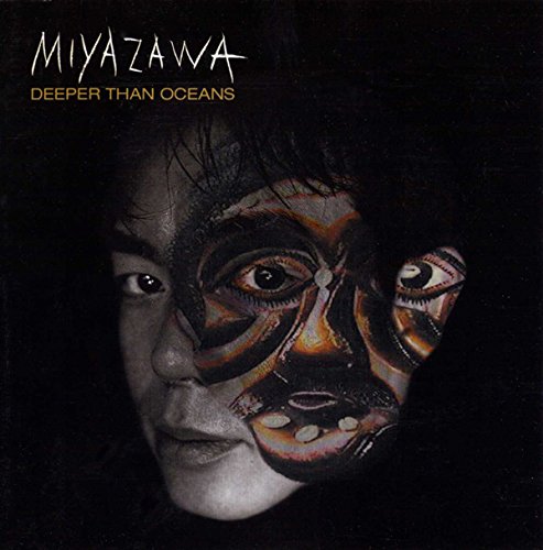 "CD cover featuring a person's face with painted designs on a black background."