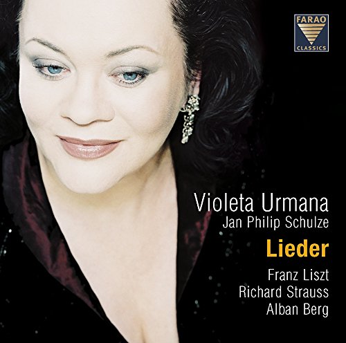 CD cover featuring a woman with blue eyes and dark curly hair against a black background.