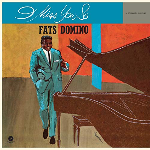 Fats Domino album cover: man at a piano, turquoise suit, abstract background.
