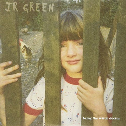 "Album cover featuring a young girl peeking through wooden slats."