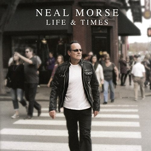 "Album cover featuring a man crossing the street, surrounded by pedestrians."