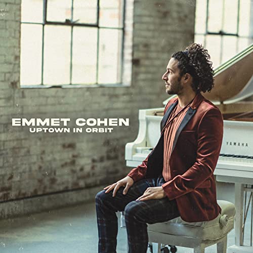 Emmet Cohen sits at a Yamaha piano, album cover for "Uptown in Orbit".