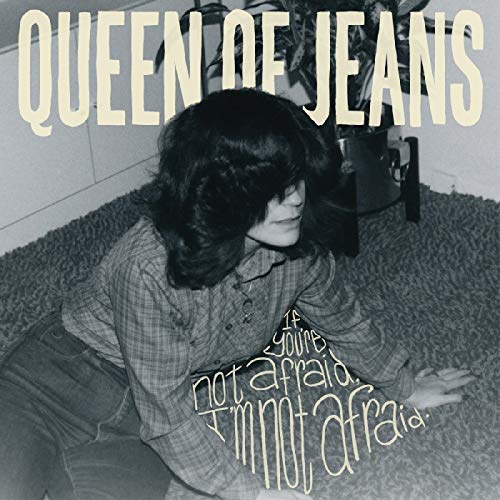 Black and white album cover with a woman sitting on the floor, text overlay.