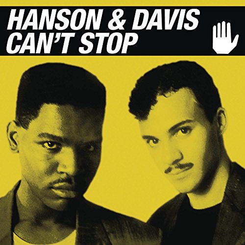 "Album cover featuring two men against a yellow background with white text."