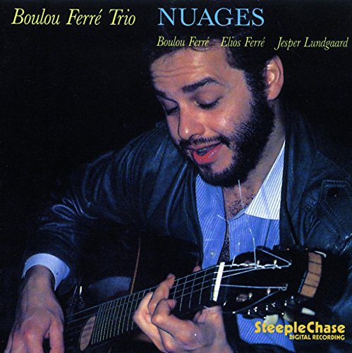 CD cover featuring a man playing an acoustic guitar, dark background.