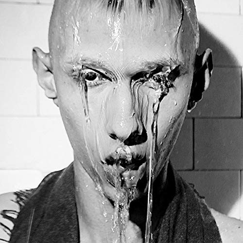 Black and white portrait of a person with liquid running down their face.