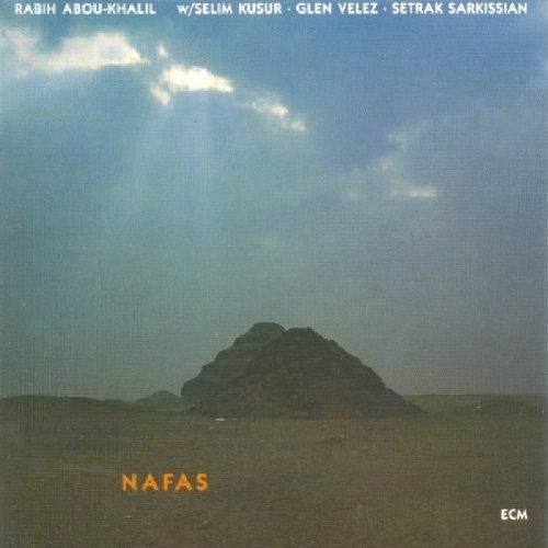 "CD cover with mountain landscape, green sky, and 'NAFAS' in orange text."
