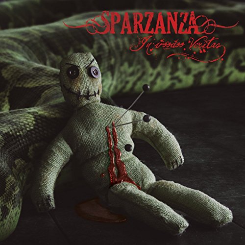 A green voodoo doll with button eyes and pins in its chest on dark wood.