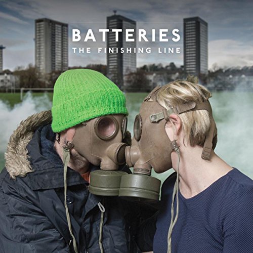 CD cover: two people in gas masks almost kissing, city background.