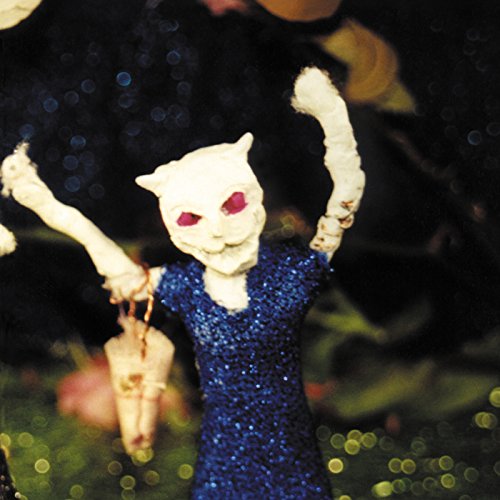Doll with a textured head and blue sparkly dress, raised arms.