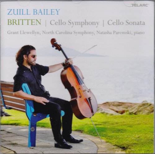 A man sits on a blue bench playing a cello outdoors.