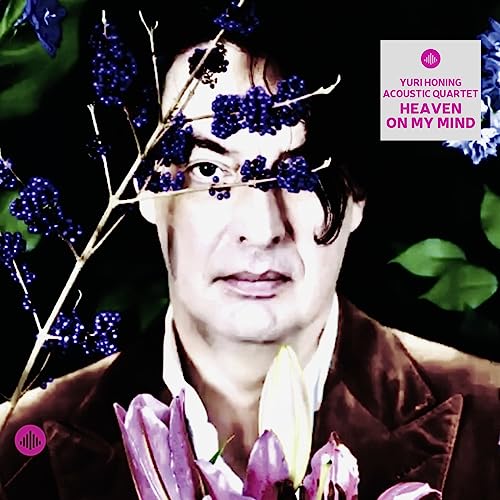 CD cover featuring a man’s face partially obscured by flowers.