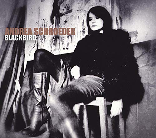 A black and white photo of Andrea Schroeder sitting on a stool.