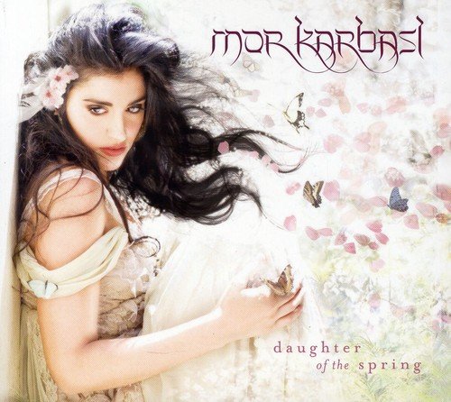 CD album cover with a woman in a white dress surrounded by butterflies and flowers.