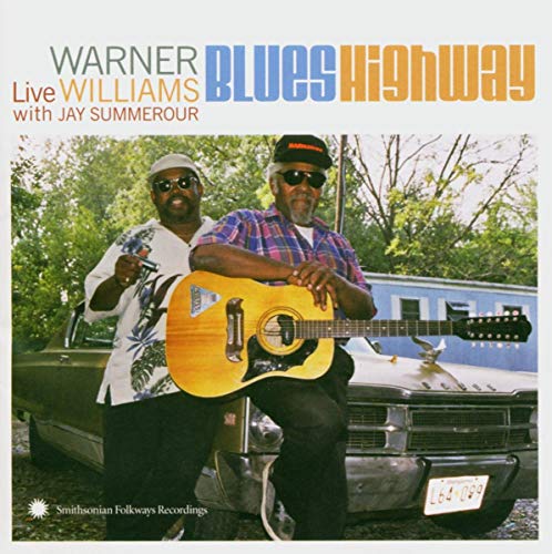 "CD cover featuring two men sitting on a vintage car, one holding a guitar."