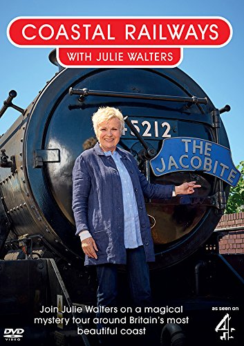 "Julie Walters stands beside a train, holding a sign that reads 'The Jacobite'."