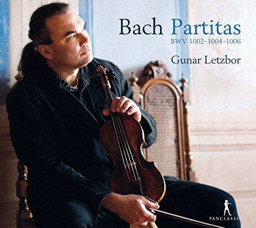 Violinist Gunar Letzbor sits holding a violin, album cover for Bach’s Partitas.