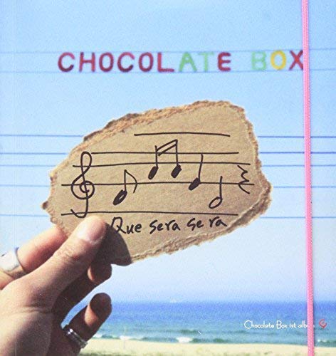 CD cover for “Que Sera Sera” with musical notes and torn paper.